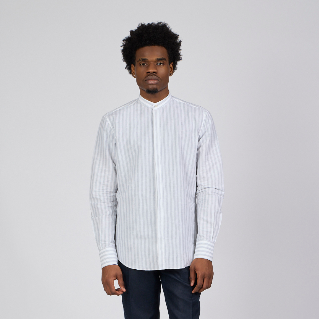 Man wearing a white striped shirt against a plain background