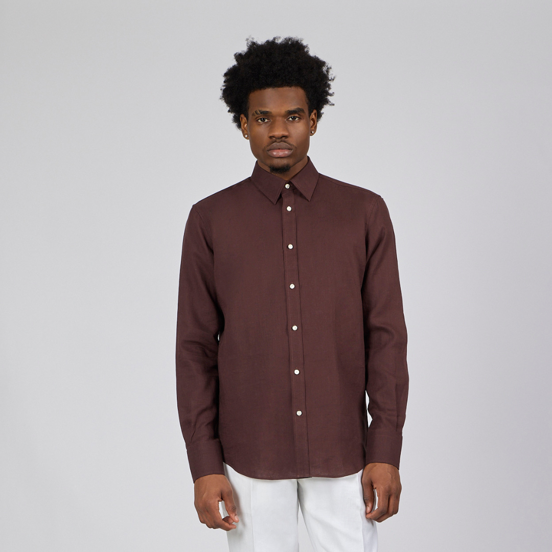 Man wearing a brown shirt against a plain background