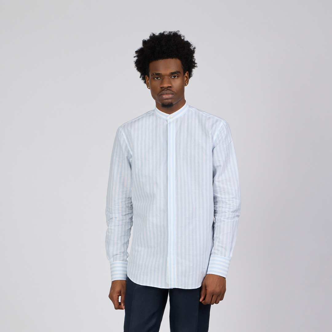 Man wearing a white striped shirt against a plain background