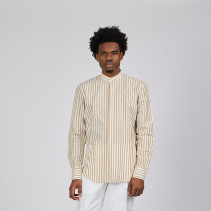Man wearing a striped shirt and white pants against a plain background-1