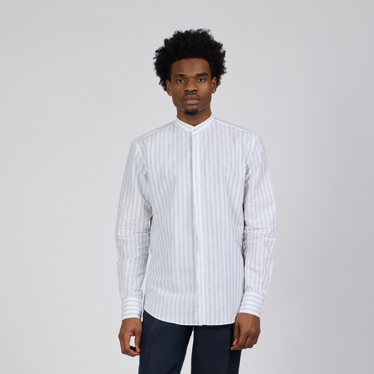 Man wearing a white striped shirt and dark pants on a white background