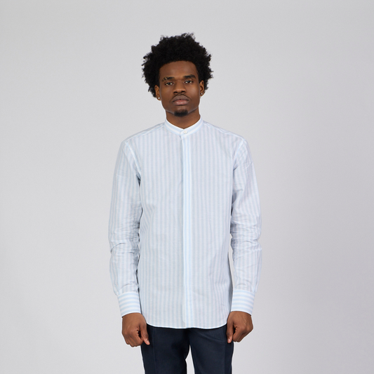 Man wearing a white striped shirt against a plain background-1