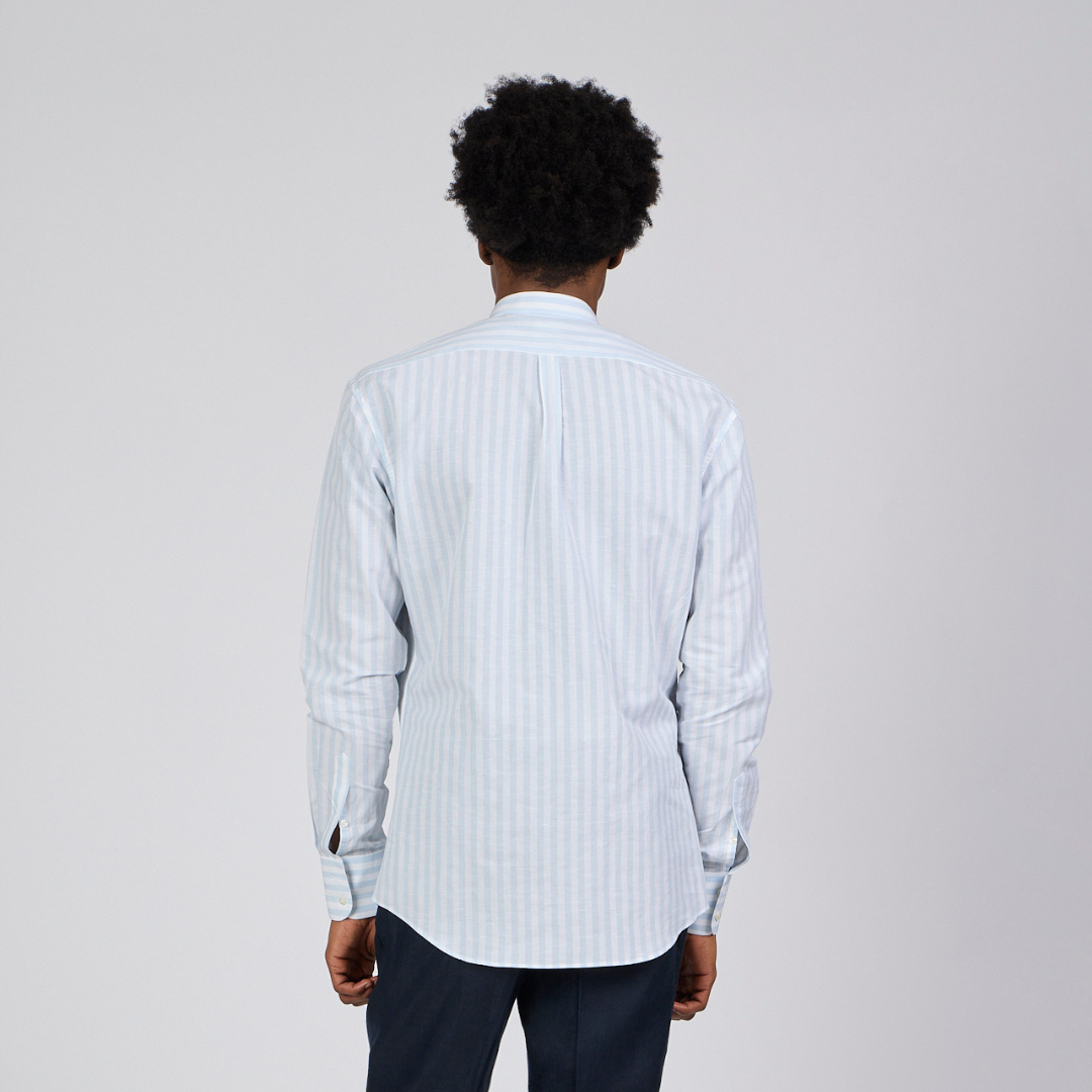 Person wearing a light blue striped shirt on a plain background-2